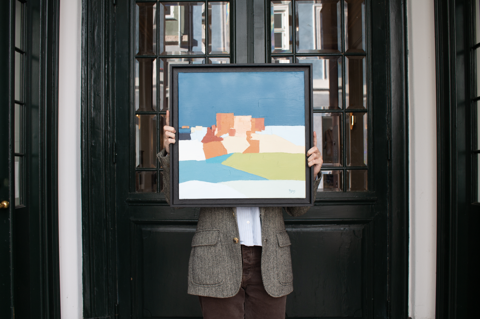Women holding painting outside